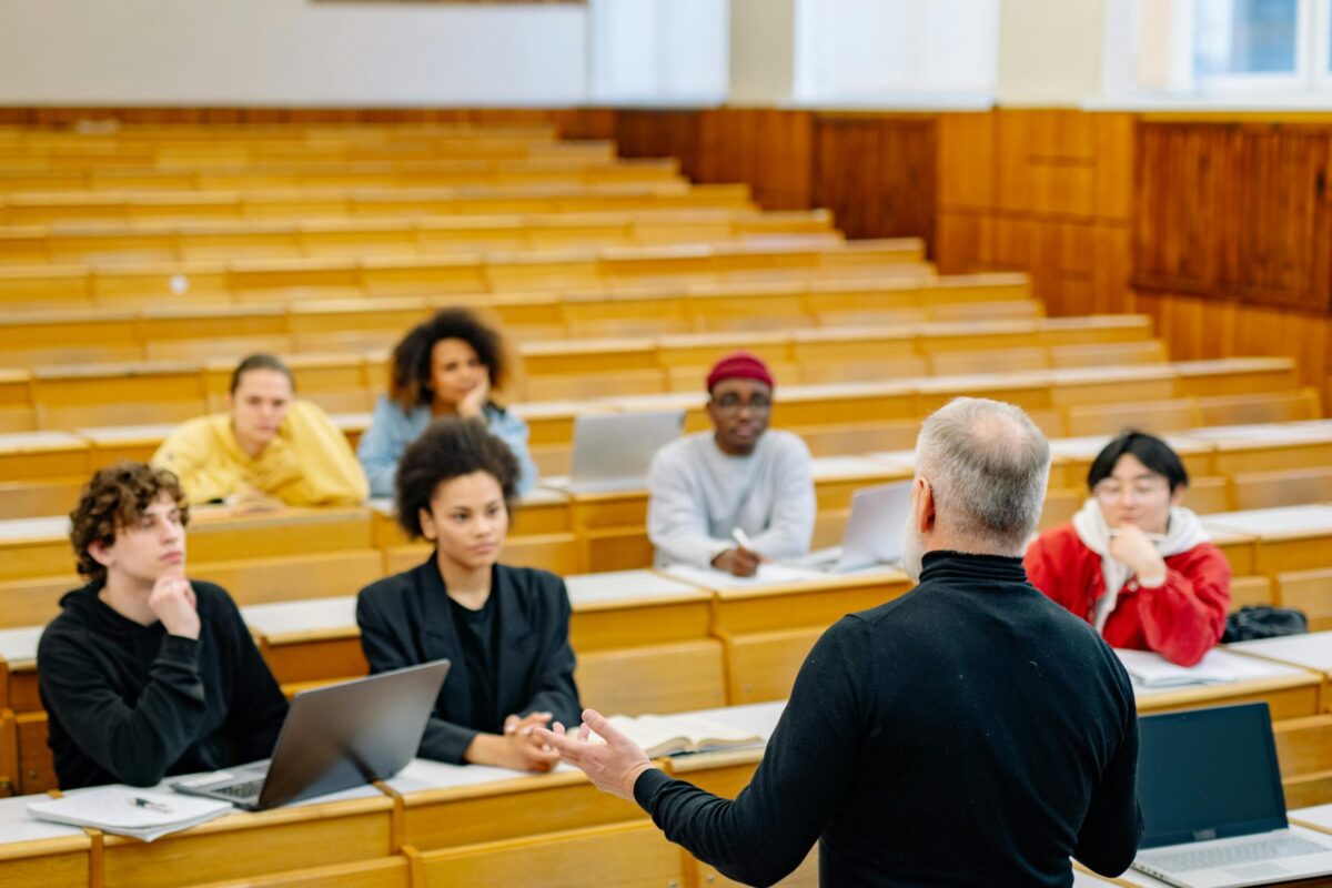 大学の講堂で授業を受ける複数の学生